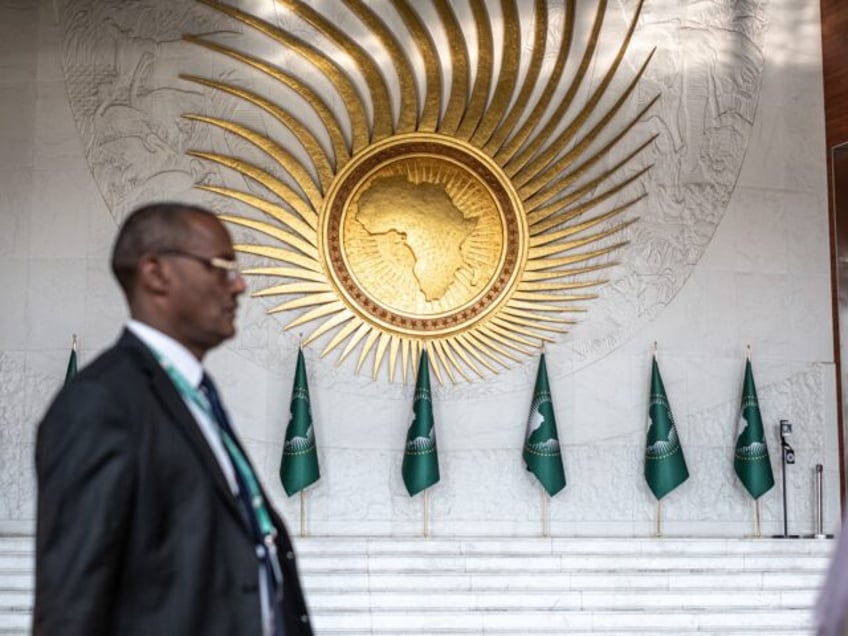 CORRECTION / An AU delegate walks of past the grand lobby of AU headquarters ahead of the