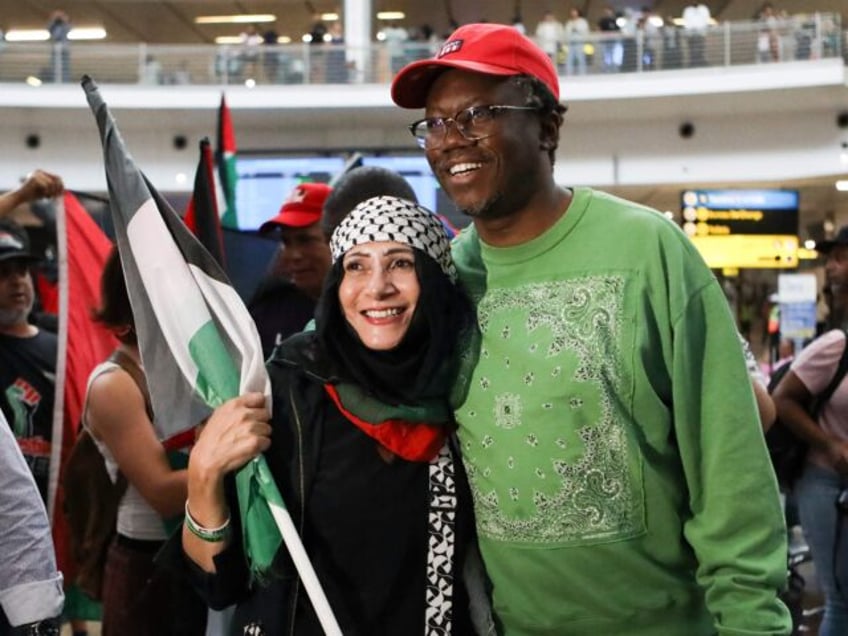 Advocate Tembeka Ngcukaitobi (R), a member of the South African legal team, is greeted by