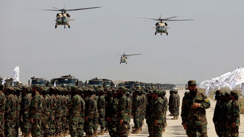 U.S.-made Black Hawk helicopters fly during a military parade to mark the third anniversary of the withdrawal of U.S.-led troops from Afghanistan at Bagram Air Base in Parwan Province on Aug. 14, 2024.