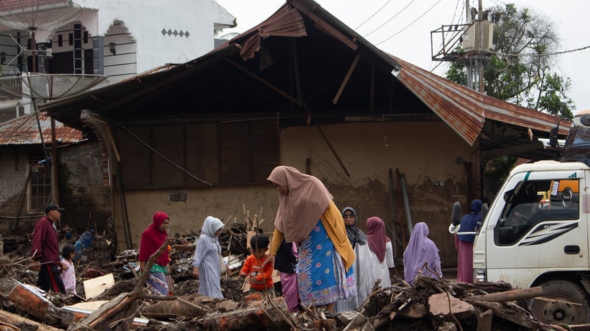 People inspect the damage by a flash flood in Tanah Datar, West Sumatra, Indonesia