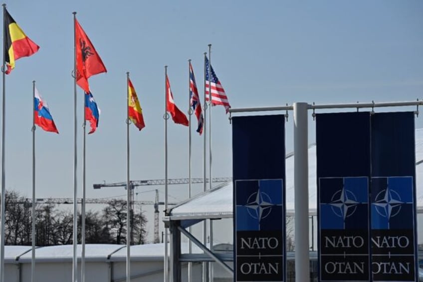 An empty mast is seen among member-nations at the NATO headquarters, ahead of a flag-raisi