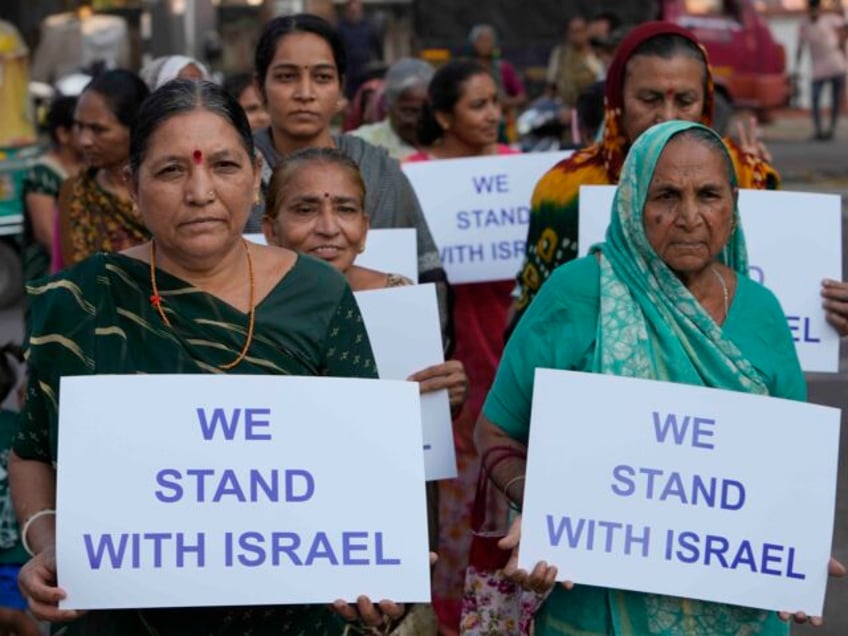 People hold placards in solidarity with Israel in Ahmedabad, India, Monday, Oct. 16, 2023.