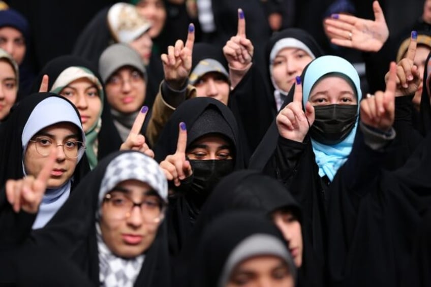 Iranian women voters showing their ink-stained fingers in a file picture from February 28,