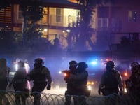 After tear gas and street fires, an Los Angeles community cleans up as National Guard troops arrive