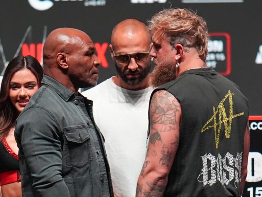 Mike Tyson, front left, and Jake Paul, front right, face off during a news conference ahea