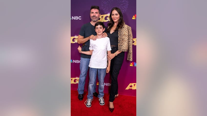 Simon Cowell with his son and fiancée at an "AGT" carpet