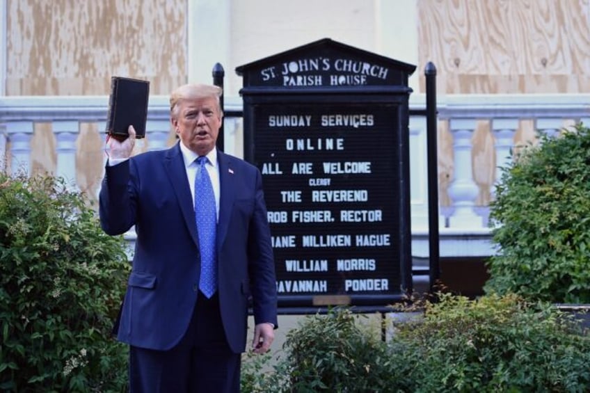 Then US president Donald Trump holds up a Bible outside of St John's Episcopal church near