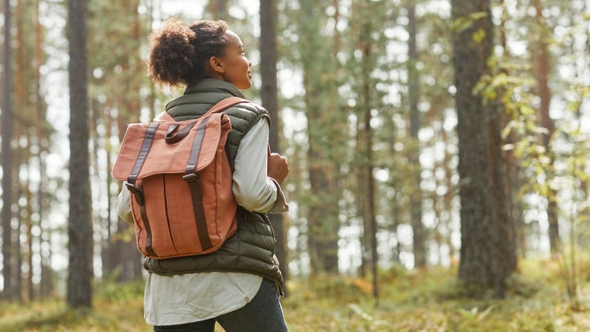 young woman hiking with backpack