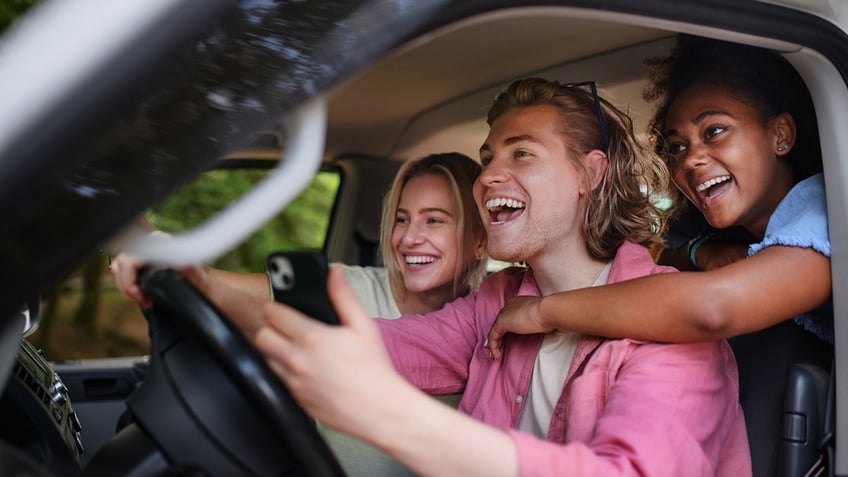 friends laugh while driving