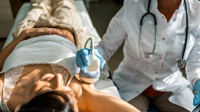 Nurse doing breast examination