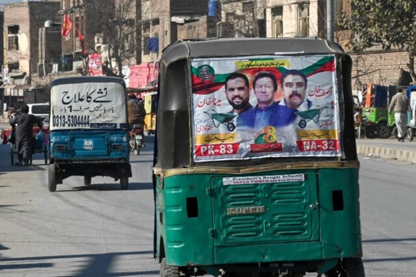 An autorickshaw with a party poster for jailed former prime minister Imran Khan in Peshawa