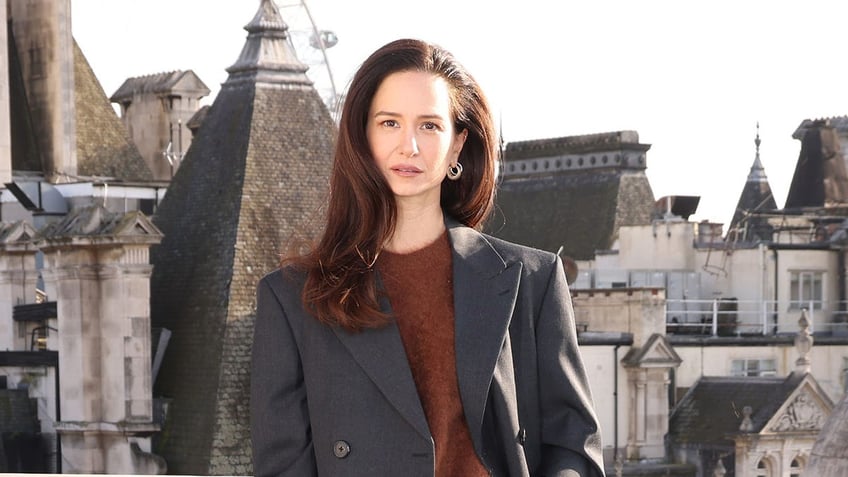 Katherine Waterston posing on a rooftop