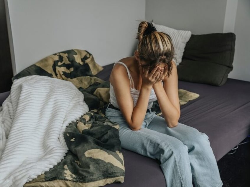 Teenage girl being sad in bedroom