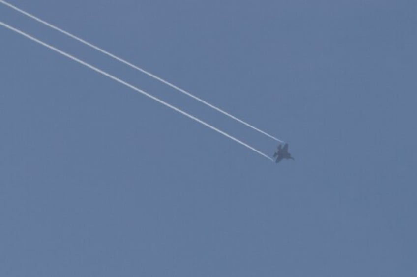 A picture taken from Israel's southern city of Sderot shows a US-made Israeli F-35 jet over the northern Gaza Strip; aid groups have called on countries to stop providing weapons to Israel and Palestinian armed groups