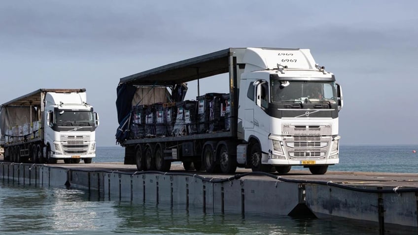 aid starts entering gaza through land after us floating pier damaged by weather