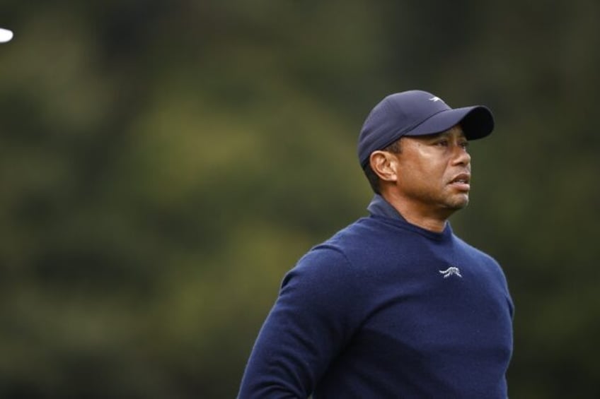 Golf superstar Tiger Woods eyes a shot prior to his withdrawal from the second round of th