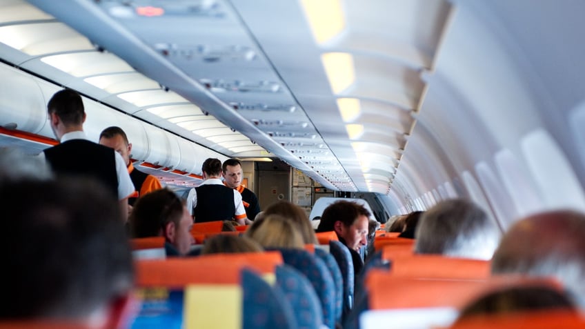 Flight crew and passengers on board airplane