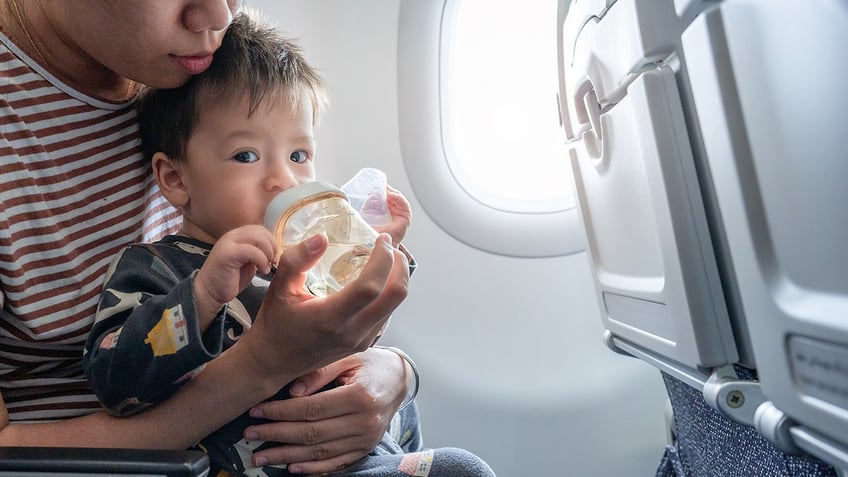 baby drinking bottle during flight