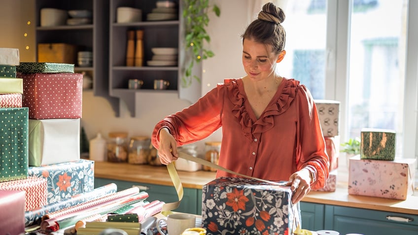 woman wrapping Christmas presents