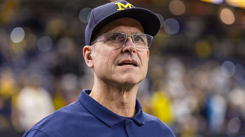 Jim Harbaugh looks on