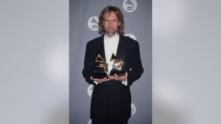 glen ballard holding his grammys for producing and co-writing jagged little pill