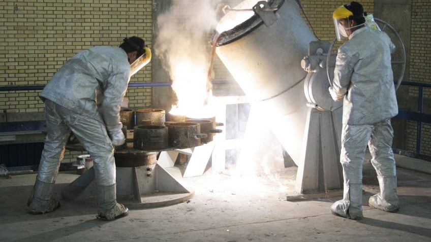 Technicians work inside a uranium conversion facility in Iran.