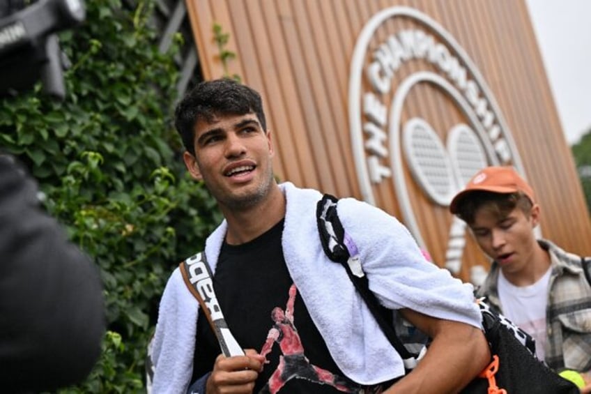 Champion: Carlos Alcaraz attends a training session at Wimbledon