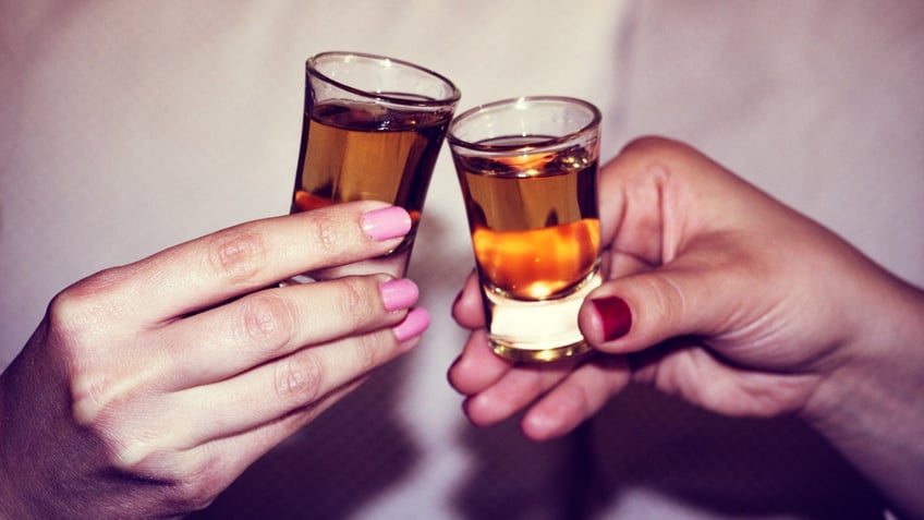 Two hands toasting whiskey on the rock, with isolated background