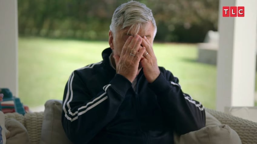 Alec Baldwin covers his face with both hands as he cries in a moment from his reality show "The Baldwins."