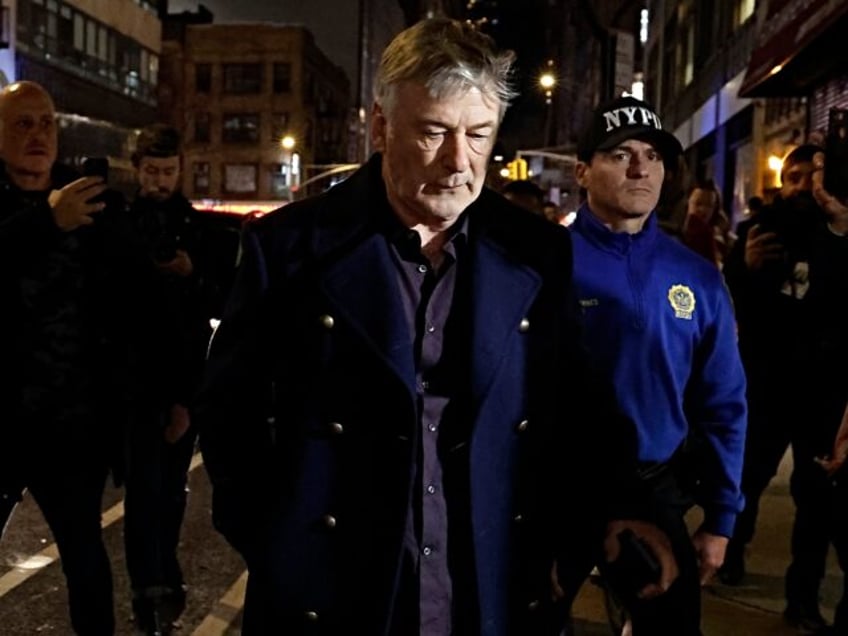 NEW YORK, NEW YORK - DECEMBER 18: Alec Baldwin is escorted away from a pro-Palestine protest by NYPD officers after clashing with protesters in Midtown Manhattan on December 18, 2023 in New York City. (Photo by John Lamparski/GC Images)