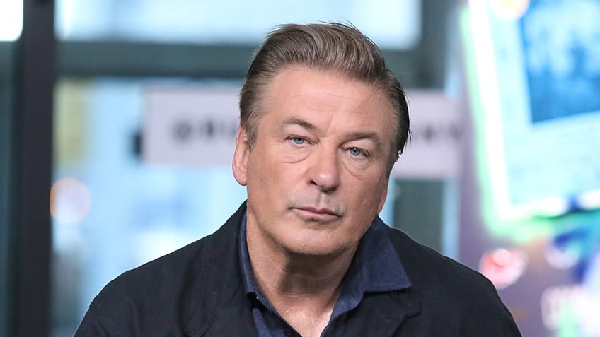 Alec Baldwin looks pensively as he promotes 
