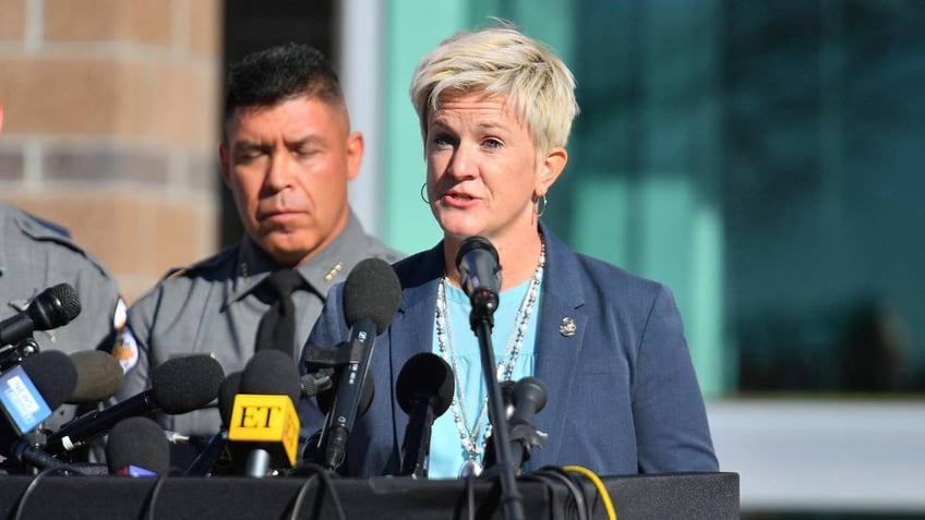 First Judicial District Attorney Mary Carmack-Altwies gives a press conference in front of a podium.