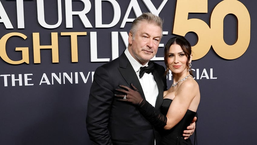 Allec Baldwin poses on the red carpet with wife Hilaria Baldwin.