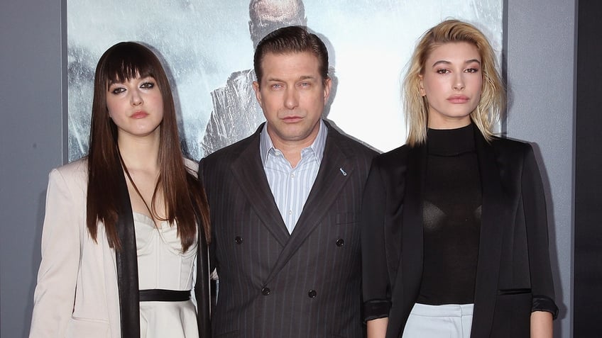 Alaia and Hailey Baldwin pose for a photo with their father Stephen