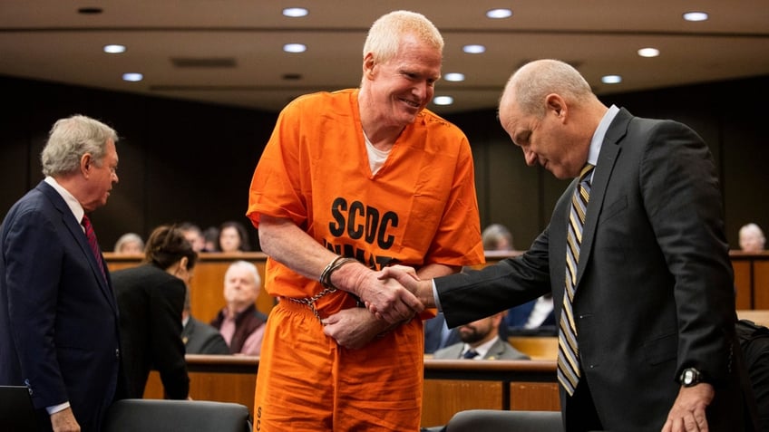 Alex Murdaugh, convicted of killing his wife, Maggie, and younger son, Paul, in June 2021, greets his defense attorney Jim Griffin before a hearing on the motion for a retrial, Tuesday, Jan. 16, 2024, at the Richland County Judicial Center, in Columbia, S.C.