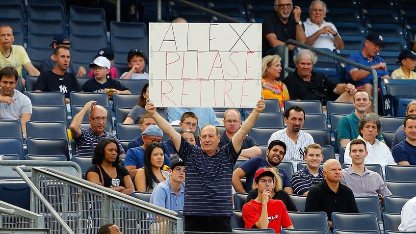 Fan holds sign