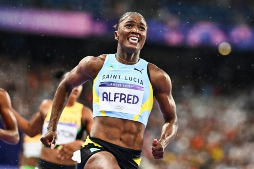 Saint Lucia's Julien Alfred celebrates after winning the women's 100m at the Paris Olympic