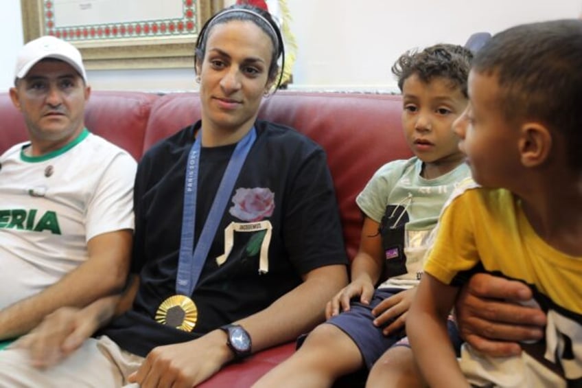 Imane Khelif poses for a picture alongside relatives in her home town of Tiaret