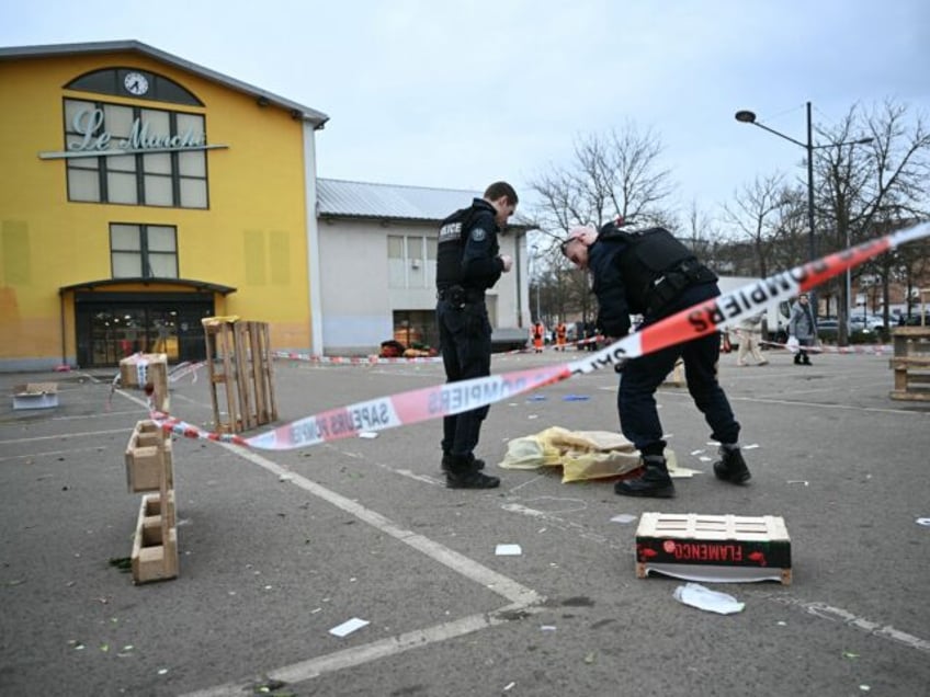 French municpal Police officers work to collect evidence at the site of a bladed weapon at