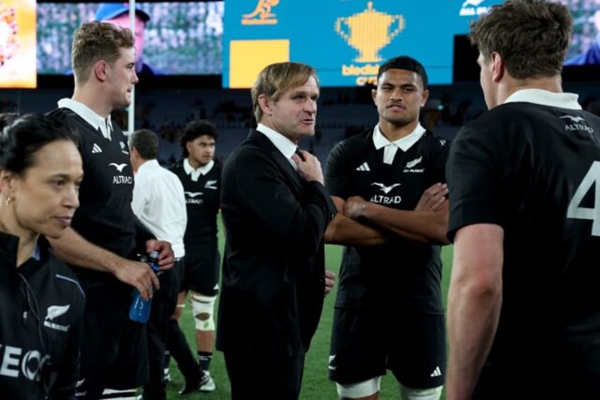 New Zealand coach Scott Robertson (C) talks to his team after they beat Australia 31-28