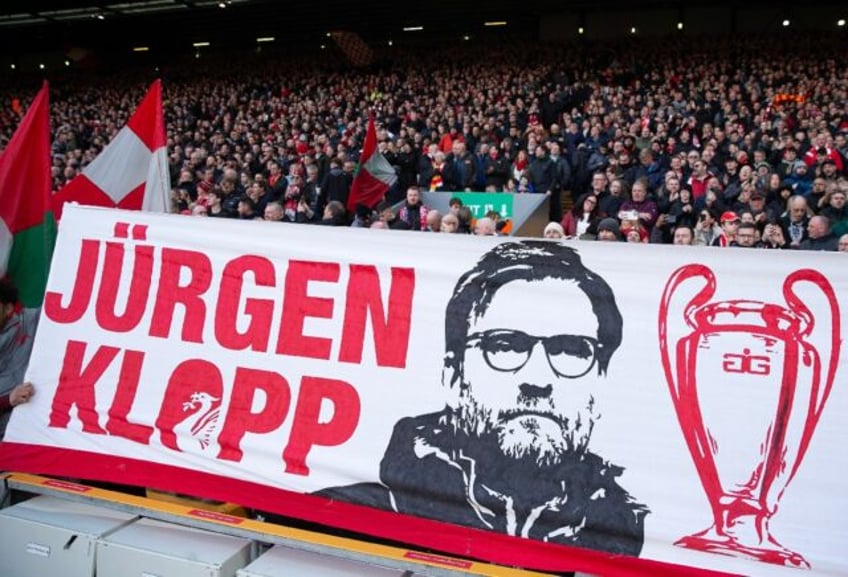 Fans favourite: Liverpool supporters display a banner featuring Liverpool's German manager