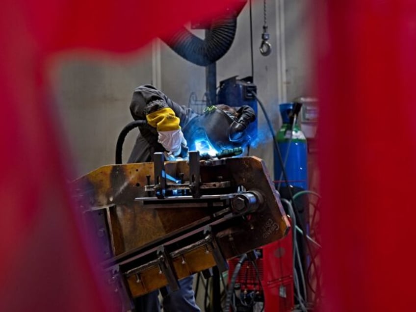 A picture taken on July 4, 2022, in Bourges shows a worker making welds on the barrel crad