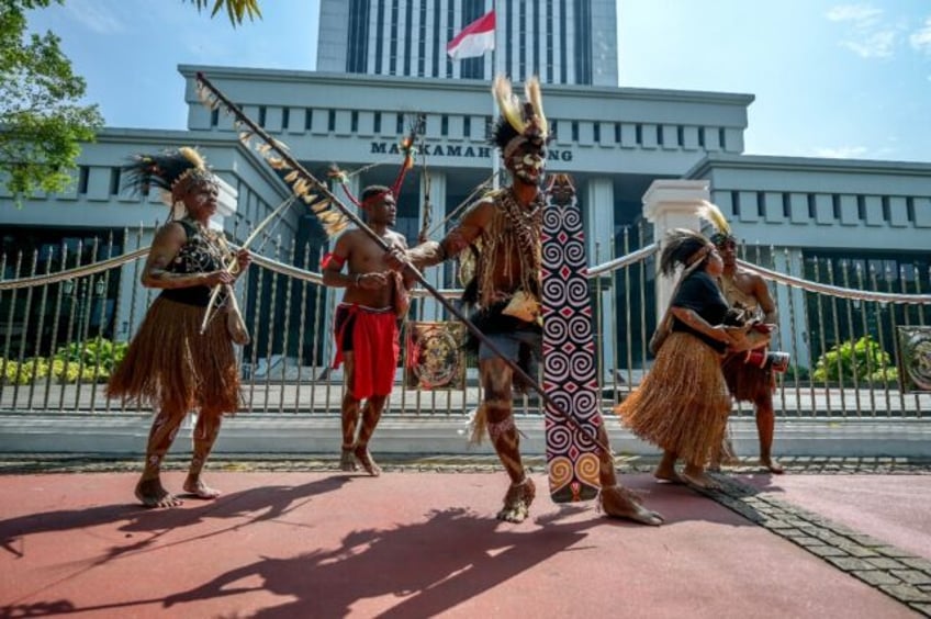 Representatives of the Awyu and Moi Indigenous tribes protest in front of Indonesia's Supr