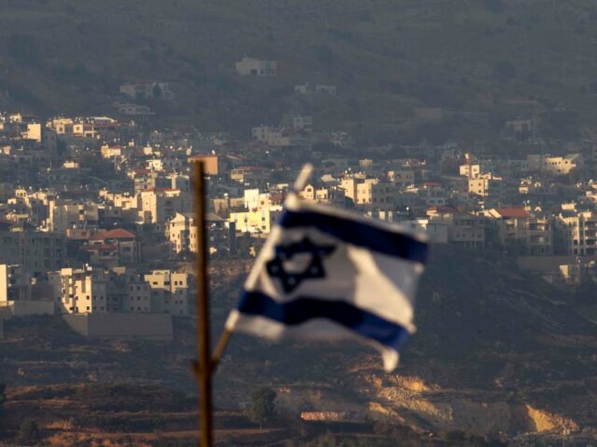 FILE - In this file photo dated Thursday, Oct. 11, 2018, an Israeli flag in front of the v