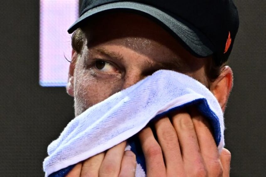Jannik Sinner washes his face during an open training ahead of his return to action at the
