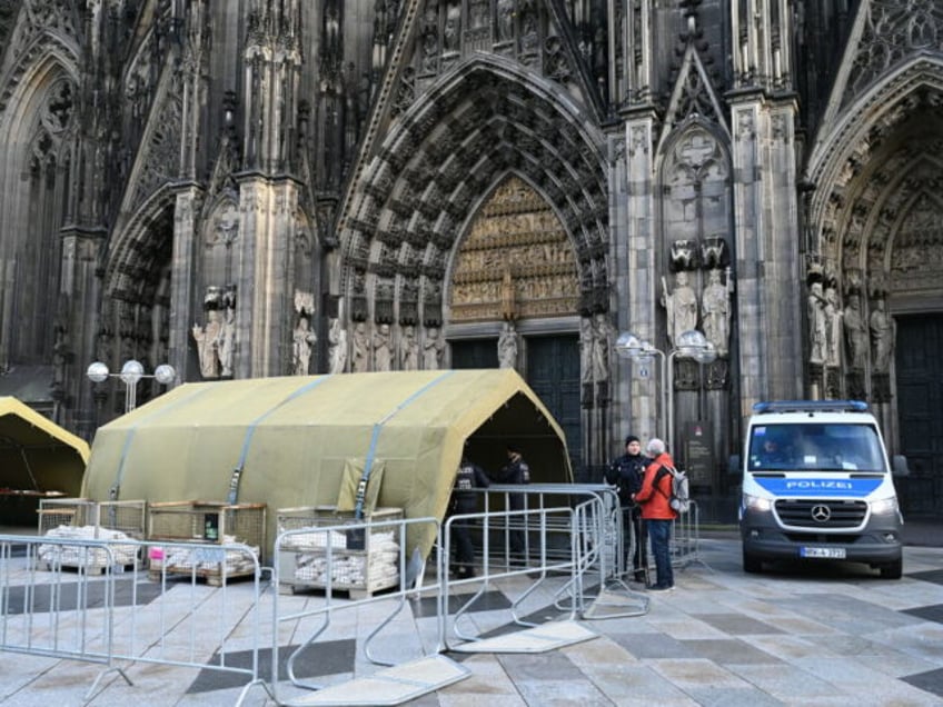 26 December 2023, North Rhine-Westphalia, Cologne: Police officers and police cars in front of Cologne Cathedral. After a terror warning, security measures at Cologne Cathedral were increased. It is considered a possible target for terrorists. Photo: Horst Galuschka/dpa (Photo by Horst Galuschka/picture alliance via Getty Images)