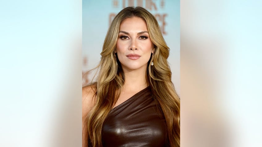 A close-up of Allison Holker wearing a one-off brown dress on the red carpet