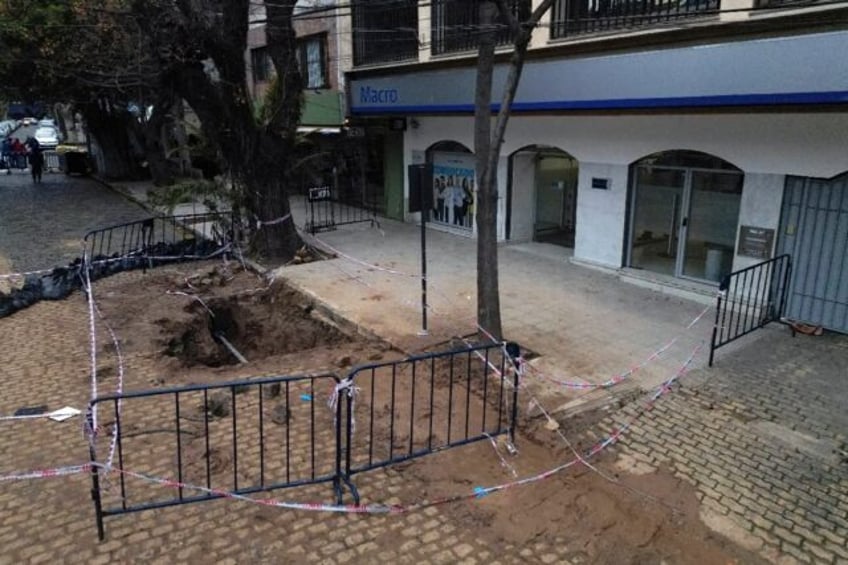 A hole in the street in front of a Banco Macro branch in San Isidro -- Argentine authoriti