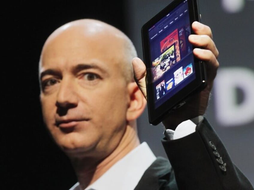 Jeff Bezos holding a kindle