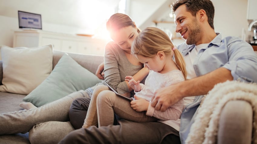 Close up of a happy young family playing at home